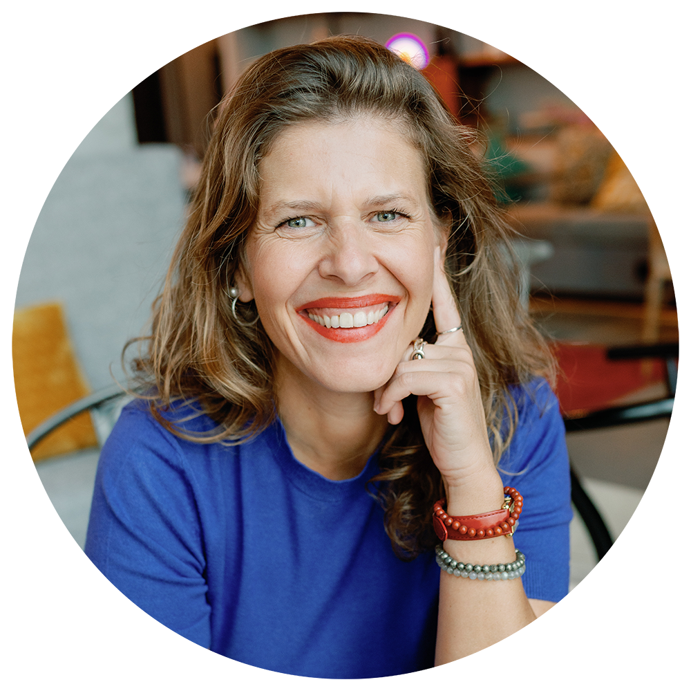 Black-and-white portrait of the business founder, Jenny Souto, smiling, with a relaxed and approachable expression.
